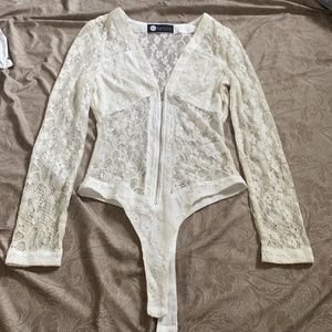 Romper it is white and gold lace detail